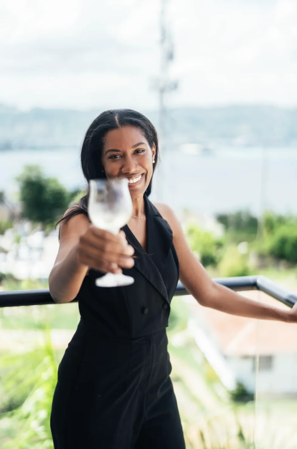 Kamilah McGann Fairclough raising a glass on a terrace in Montego Bay