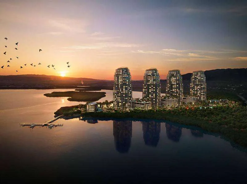 Computer-generated image of The Pinnacle's four towers on the Reading Peninsula at sunset, reflected in the Montego Bay lagoon, with the marina in the foreground