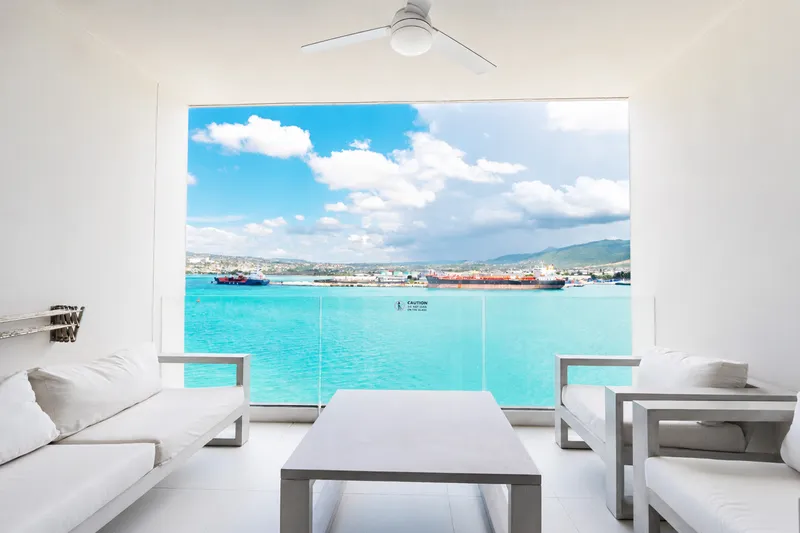 Balcony lounge at Soleil Residences framing the turquoise water of Montego Bay